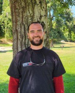 American River hauling employee Duke Krygier smiling in front of a tree in a park